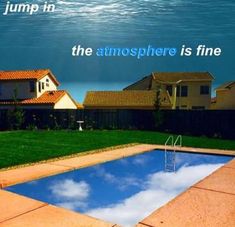 an empty swimming pool with the words jump in the atmosphere is fine above it are houses and a body of water