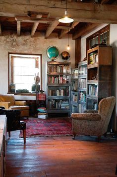 a living room filled with furniture and bookshelves