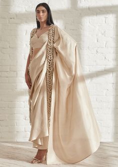 Understated yet makes a statement. The hand beaded pearl bead jacket lends an elegant touch to the pre draped masai godet sari. Layer it over any soft color outfit or over your favorite white shirt. Pair it with our plain Gatsby blouse. Luxury Sheer Dupatta Blouse Piece For Transitional Season, Luxury Festive Choli With Draped Sleeves, Luxury Floor-length Glamorous Blouse Piece, Luxury Party Blouse Piece, Luxury Blouse Piece For Diwali With Traditional Drape, Luxury Draped Cutdana Blouse Piece, Luxury Gown With Unstitched Blouse For Festivals, Luxury Blouse With Draped Sleeves For Parties, Luxury Glamorous Georgette Tops