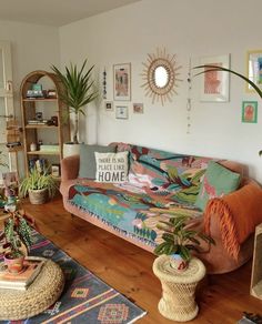 a living room filled with furniture and plants