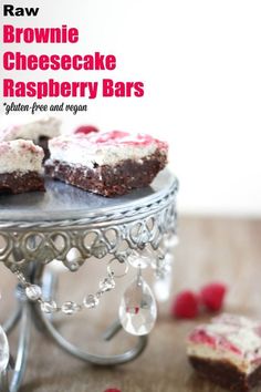 brownie cheesecake raspberry bars on a cake stand