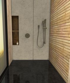 a bathroom with a walk in shower next to a wooden wall