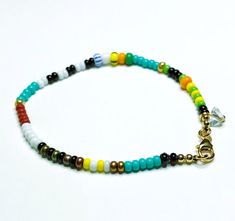 This playful, handcrafted bracelet boasts multicolored glass beads, a non-tarnishing stainless steel clasp, and a delicate, faceted glass charm.  The bracelet features a double string design on a black silk thread and is approximately 7.5 inches in length. The small glass beads measure roughly 3 to 4 mm in diameter. The bracelet will be delivered in a compact, cotton-filled Kraft box, ideal for storage or as a gift. Colors may vary slightly from your screen to real life. ⚠️This bracelet is not s Heishi Beads Jewelry With Colorful Beads For Friendship, Faceted Heishi Beads Bracelets As Gift, Everyday Multicolor Jewelry With Tiny Beads, Everyday Multicolor Beaded Jewelry, Czech Glass Bracelets With Tiny Beads As A Gift, Everyday Rainbow Beaded Bracelets With Tiny Beads, Rainbow Beaded Bracelets With Faceted Beads For Gift, Rainbow Faceted Beads Bracelet As Gift, Multicolor Czech Glass Hand-strung Beaded Bracelets