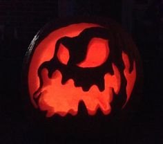 a carved pumpkin with an evil face on it