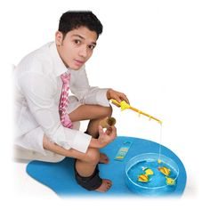 a young man is sitting on the floor playing with his toy fish and goldfish