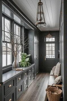 a room that has some drawers and a couch in it with a plant on the window sill