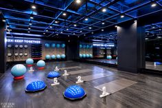 there are many blue balls on the floor in this room with mirrors and other objects