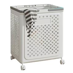 a white laundry basket on wheels with a black and white towel