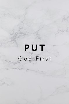 the words put god first on a white marble background