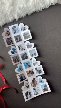 a bunch of pictures that are on top of a table next to a red ribbon