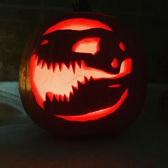 a carved pumpkin with an alligator's teeth on it