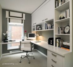 a home office with built in shelving units