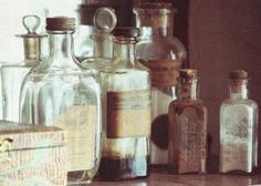 an assortment of glass bottles sitting on top of a counter