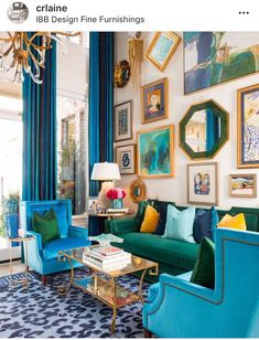 a living room filled with blue and green furniture next to a wall covered in pictures