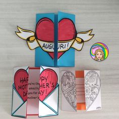 valentine's day cards, envelopes and magnets are displayed on a table