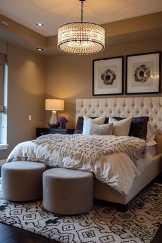 a bedroom with a large bed and chandelier