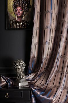 a busturine sitting on top of a table next to a painting and curtain