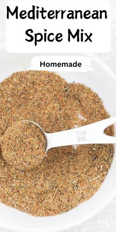 homemade mediterranean spice mix in a white bowl with a spoon on the side and text overlay