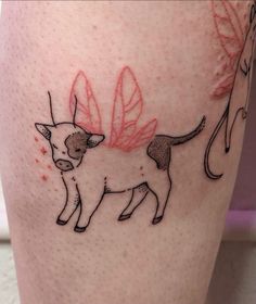 a tattoo on the leg of a person with a cat and butterfly design on it