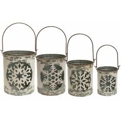 four metal snowflake buckets are lined up against each other on a white background