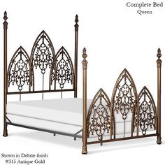 the bed is made up and has intricate ironwork