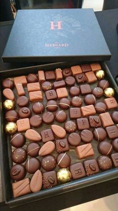 a box filled with lots of chocolates on top of a table