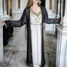 Make a statement this Ramadan and Eid with our exquisite set of two featuring a hand-beaded Moroccan style kaftan and dress! Each piece is meticulously crafted with luxurious fabric and adorned with shimmering crystals and rhinestones, creating a dazzling ensemble that exudes elegance and sophistication. The flowing silhouette of the kaftan caftan offers effortless glamour, while the stylish abaya adds a touch of modesty and refinement to your look. Whether it's for Iftar gatherings or Eid celeb Luxury Long Sets For Eid, Arabic Abaya, Stylish Abaya, Eid Celebrations, Arabic Fashion, Black Abaya, Moroccan Kaftan, Women Outfit, Moroccan Style