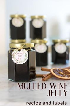 a jar of mulled wine jelly next to cinnamon sticks