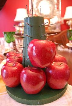 there are many apples stacked on top of each other in the shape of a tower