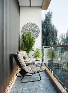 a chair sitting on top of a balcony next to a potted plant