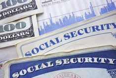 several social security cards are stacked on top of each other with dollar bills in the background