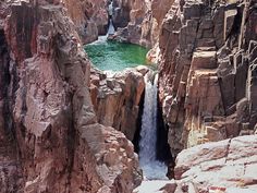 there is a waterfall in the middle of some rocks