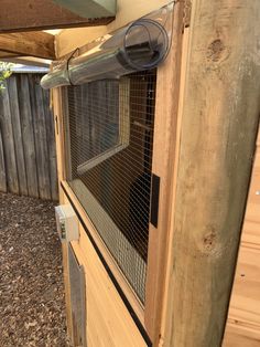 a large bird cage sitting on top of a wooden door