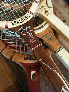 several wooden tennis rackets are stacked on top of each other