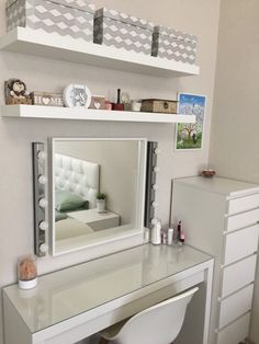 a white desk with a mirror and stool