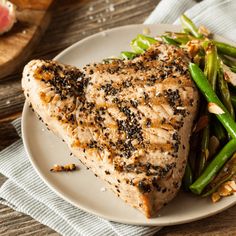 a white plate topped with meat and green beans