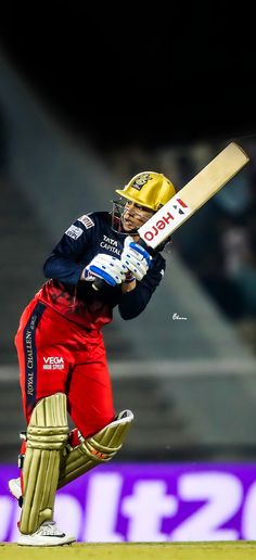 a man holding a bat on top of a field