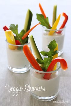 three small cups filled with vegetables and yogurt