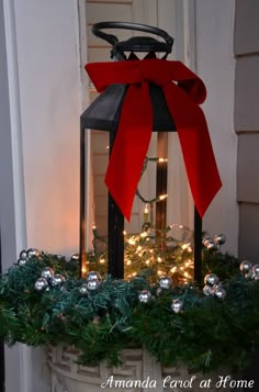 a lantern with a red bow on it