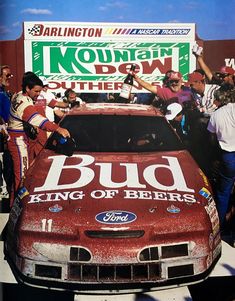 a red car with the words bud king of beers painted on it