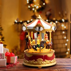 a merry go round carousel with horses and people on it next to presents in front of a christmas tree