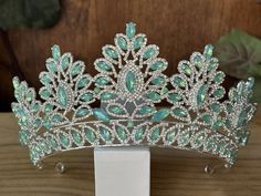 Beautiful, sparkles, good quality Tiara with big Sage Rhinestone set on silver Tiara. Perfect for Prom, Birthday, Sweet 16, Quinceanera, Anniversary, Wedding, or for any other special occasion. Or just to be THE QUEEN. THE COLORS ON THE TIARA: Silver the tiara frame, Sage and Crystal Rhinestone THE SIZE 3.5" tall on the front. 2.5" tall on the sides. GIFT BOX IT'S NOT INCLUDED! This item it will send on STANDARD FIRST CLASS MAIL (2 to 5 business days). in USA If you need sooner, please upgrade t Green Quinceanera Decor, Green Quince Tiara, Sage Green Quinceanera Crown, Green Crown Quince, Sage Green Crown, Sage Green Tiara, Quinceanera Light Green Crown, Jade Tiara, Crowns For Quinceanera