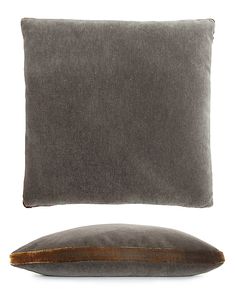 a gray pillow and brown pillow on a white background