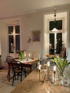 a dining room table with candles on it