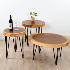 three wooden tables with hairpin legs and a bottle of wine