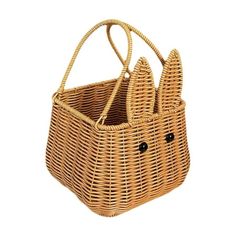 a wicker bag with two small black buttons on the front and one large brown ratchet