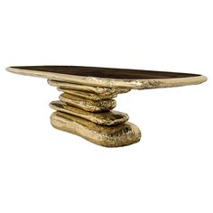 a table that has some gold colored rocks on top of it and is made out of wood