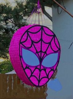 a spiderman lantern hanging from the side of a building