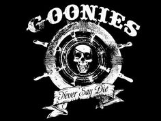 the goonies never say die t - shirt is black with white lettering and a skull on