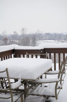 the table and chairs are covered in snow